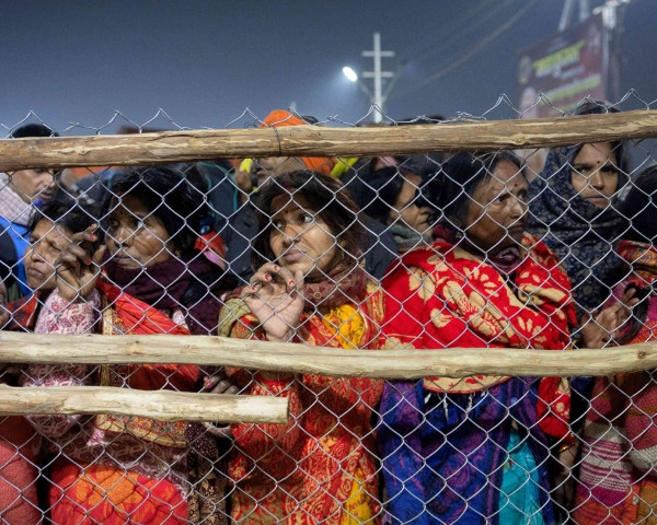 Devotees stopped by policemen at a barricade following the crowd crush. Photo: Reuters