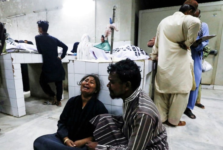 people mourn the death of a relative who was killed along with others in a stampede during handout distribution at a hospital morgue in karachi pakistan march 31 2023 reuters akhtar soomro