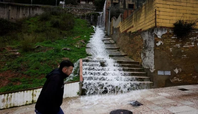 a man walks as water flows down stairs in a street due to heavy rains as storm leonardo hits parts of spain in benaojan spain on feb 6 2026 photo reuters