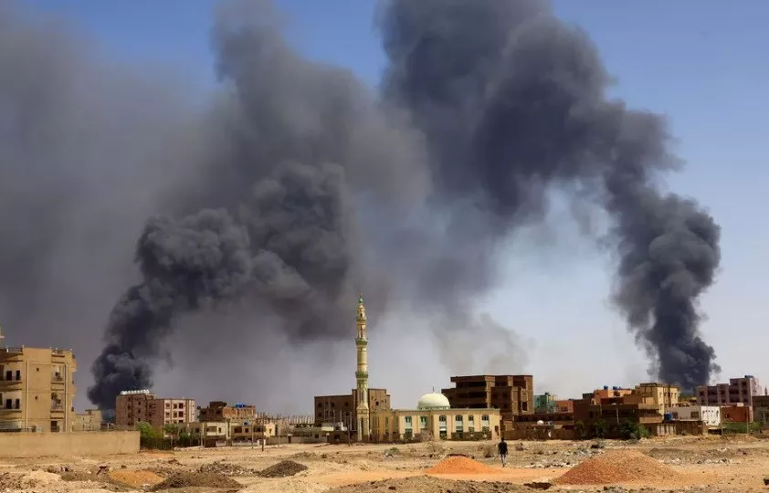 a man walks while smoke rises above buildings after aerial bombardment during clashes between the paramilitary rapid support forces and the army in khartoum north sudan may 1 2023 reuters mohamed nureldin abdallah a man walks while smoke rises above buildings after aerial bombardment during clashes between the paramilitary rapid support forces and the army in khartoum north sudan may 1 2023 reuters mohamed nureldin abdallah