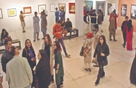 visitors admire paintings on display during the sufi festival at alhamra in lahore photo ppi