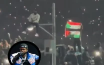 protester waving palestinian and sudanese flags removed during super bowl halftime show protester waving palestinian and sudanese flags removed during super bowl halftime show