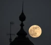 the supermoon known as the beaver moon is seen behind an office building in mexico city on november 4 2025 photo afp