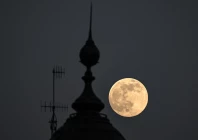 the supermoon known as the beaver moon is seen behind an office building in mexico city on november 4 2025 photo afp