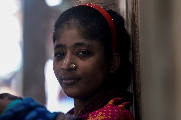 This photo shows a sex worker standing next to a brothel in Daulatdia in Rajbari District. PHOTO: AFP