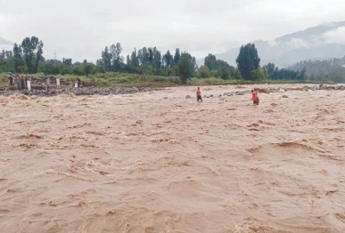 rescue workers scour the swollen swat river for bodies of missing persons after a devastating cloudburst triggered flash floods in the region photo nni