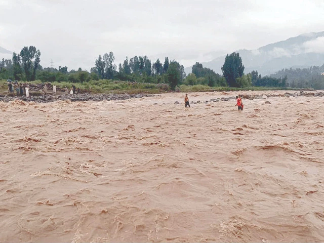 rescue workers scour the swollen swat river for bodies of missing persons after a devastating cloudburst triggered flash floods in the region photo nni