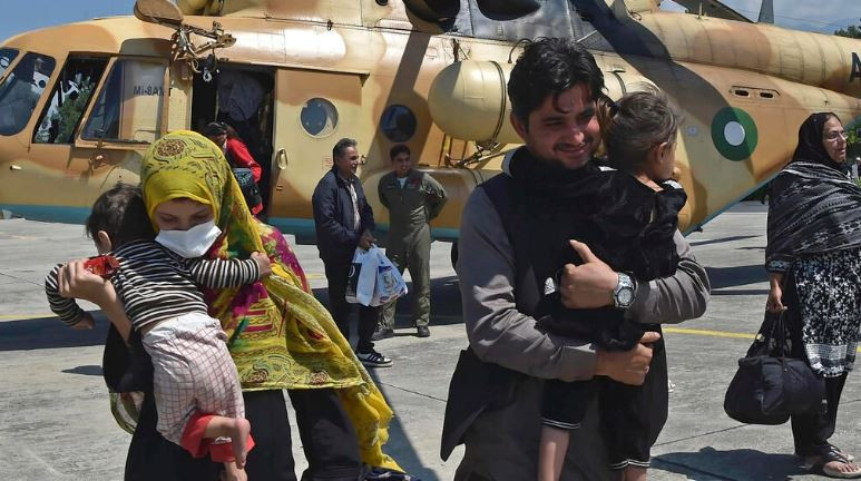 local tourists disembark from a pakistani army helicopter after they were rescued from flood hit tourist areas in the north photo afp