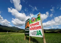 a sign stands in a field between eichenwies and eichberg on the day of the vote on a plan backed by the right wing swiss people s party svp to limit population growth to 10 million inhabitants switzerland june 14 2026 reuters
