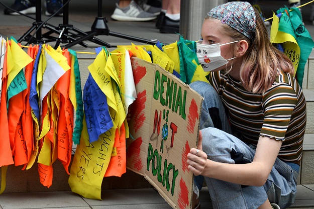 A student holds a sign during a rally calling for action on climate change in front of the Liberal Party headquarters in Sydney. PHOTO: AFP