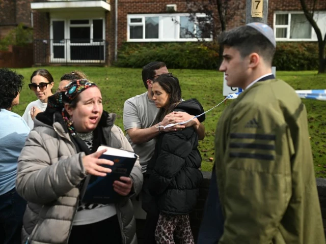 members of the community comfort each other near heaton park hebrew congregation synagogue in crumpsall north manchester on october 2 2025 following a major incident at the synagogue photo afp