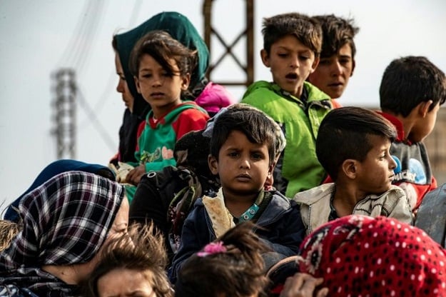 Syrian women and children flee the countryside of the northeastern Syrian town of Ras al-Ain on the Turkish border. PHOTO: AFP
