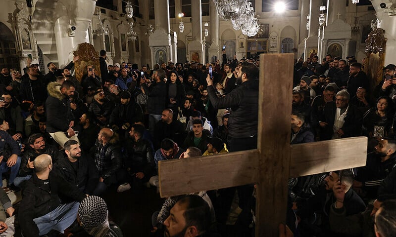 christian youths stage a sit in inside the mariamite church in damascus early on dec 24 2024 photo afp