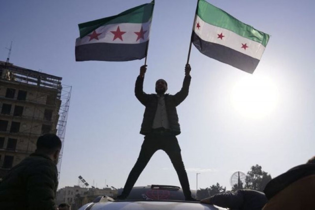 a man holds the syrian opposition flag as they celebrate after syria s army command notified officers on sunday that president bashar al assad s 24 year authoritarian rule has ended a syrian officer who was informed of the move told reuters following a rapid rebel offensive that took the world by surprise in aleppo syria december 8 2024 reuters karam al masri a man holds the syrian opposition flag as they celebrate after syria s army command notified officers on sunday that president bashar al assad s 24 year authoritarian rule has ended a syrian officer who was informed of the move told reuters following a rapid rebel offensive that took the world by surprise in aleppo syria december 8 2024 reuters karam al masri