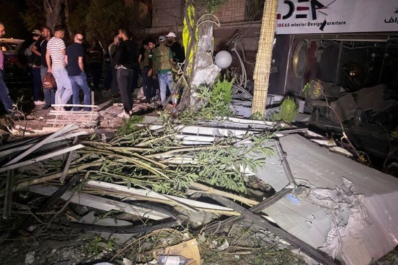 people gather near the site of an israeli airstrike that targeted a residential building in the mezzah suburb in western damascus according to syrian state media syria october 2 2024 photo reuters