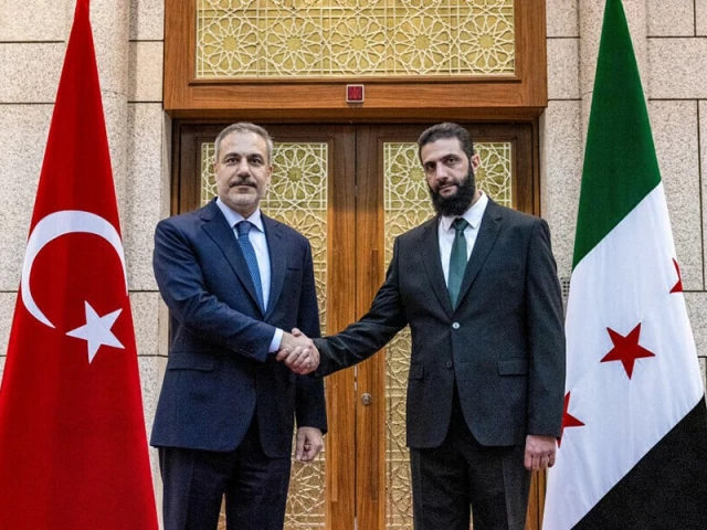 this handout picture released by the turkish foreign ministry press service shows turkiye s foreign minister hakan fidan l being received by hayat tahrir al sham hts leader ahmed al sharaa also known as abu mohammad al jolani in damascus on december 22 2024 photo afp this handout picture released by the turkish foreign ministry press service shows turkiye s foreign minister hakan fidan l being received by hayat tahrir al sham hts leader ahmed al sharaa also known as abu mohammad al jolani in damascus on december 22 2024 photo afp