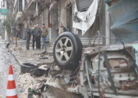 men walk towards a destroyed vehicle following a ceasefire in the kurdish majority ashrafiyeh neighbourhood of aleppo photo afp