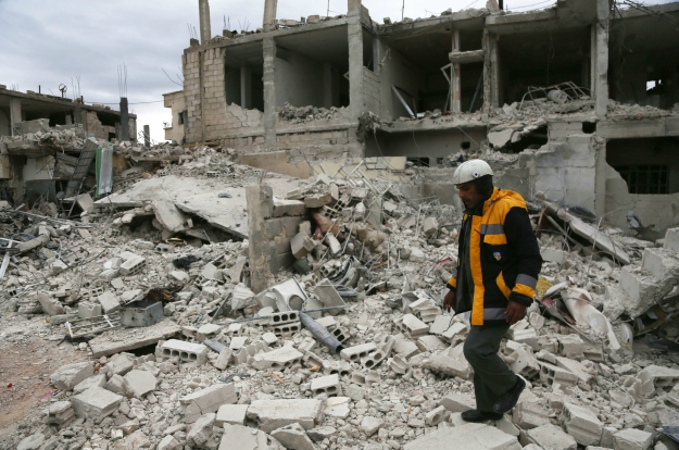 Samir Salim, rescuer with the White Helmets, on a bombarded site. PHOTO: AFP