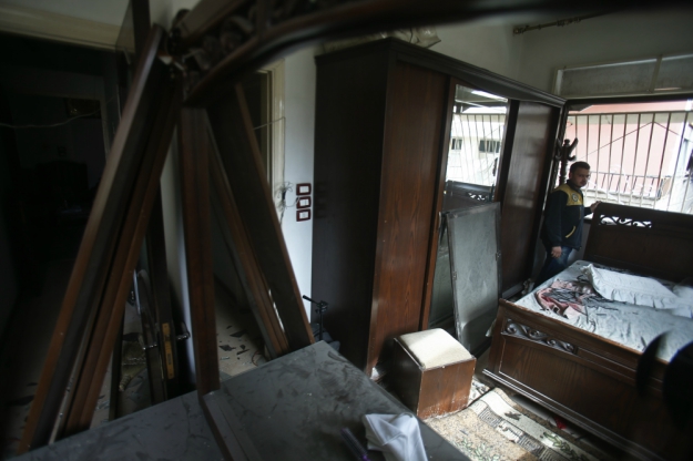 Twenty-seven-year-old member of the White Helmets rescue forces, Saeed al-Masri, stand in his home in Saqba that was hit in bombardment the previous week in Syria's Eastern Ghouta. PHOTO: AFP