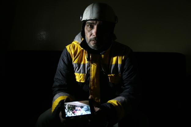Samir Salim shows a picture that he took when he tried to rescue the body of his mother from under the rubble of his home. PHOTO: AFP
