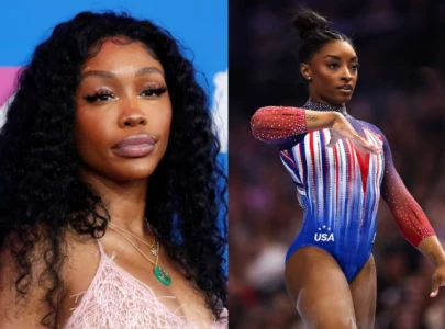 sza shares she used to be a gymnast proving it with splits and handstands to idol simone biles