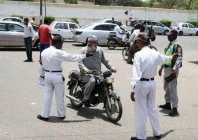 traffic police officers questioning to a bike rider in karachi photo express