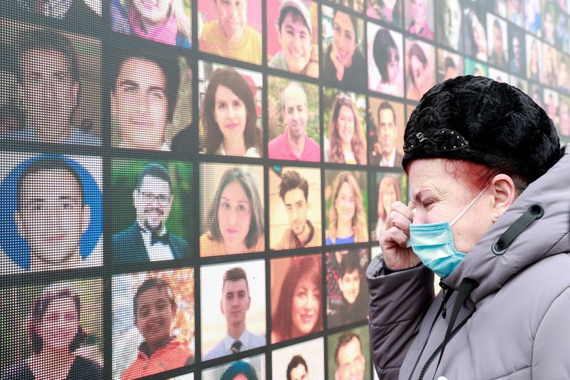 a victim s relative mourns during a commemorative ceremony which marks the first anniversary of the ukraine international airlines flight ps752 downing in iranian airspace in kyiv ukraine january 8 2021 reuters