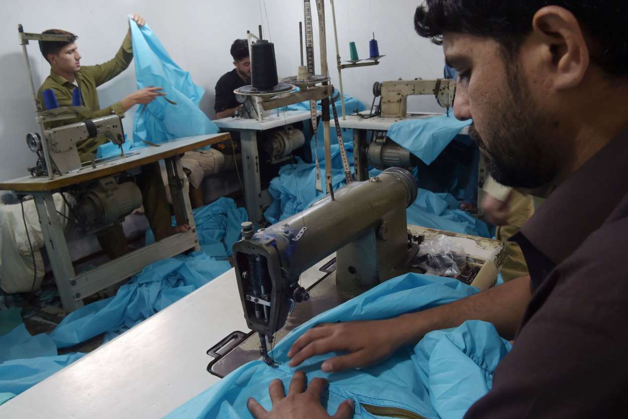 tailors stitching ppe photo afp