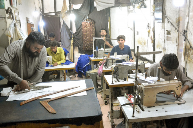 a master tailor cuts fabric while the rest of his workers sew clothes at a tailoring workshop at a commercial centre in karachi photo express a master tailor cuts fabric while the rest of his workers sew clothes at a tailoring workshop at a commercial centre in karachi photo express