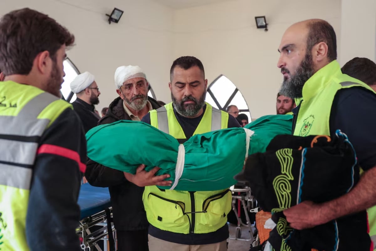 A member of civil defence personnel holds the body of Taleen Saeed, 1.5 years old, killed in an Israeli strike in the village of Srifa, at the Al Kharab mosque in Tyre, Lebanon, April 12, 2026. PHOTO: REUTERS