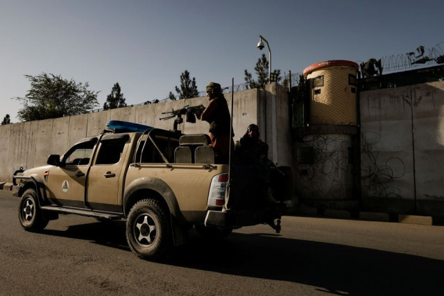 taliban fighters ride on the back of a pickup truck as they patrol along a road in kabul afghanistan october 23 2021 photo reuters