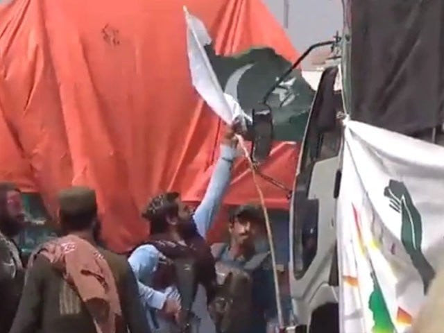on sunday some taliban border security guards posted at the torkham border and a few civilians removed pakistani flags from trucks carrying aid to afghanistan screengrab