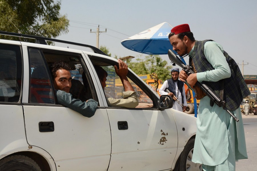 a taliban member checks a vehicle at a security checkpoint in jalalabad capital of nangarhar province afghanistan aug 31 2021 photo xinhua