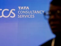 a man walks past a logo of tata consultancy services tcs before a press conference announcing the company s quarterly results in mumbai india january 11 2024 reuters