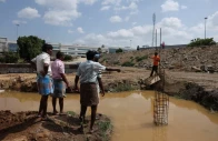 farmers speak with a security guard near the compound wall of a tata electronics components factory for apple s iphone in hosur june 15 2026 reuters