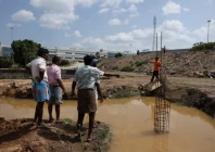 farmers speak with a security guard near the compound wall of a tata electronics components factory for apple s iphone in hosur june 15 2026 reuters