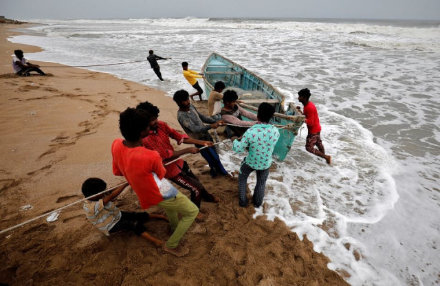 people move a fishing boat to a safer place along the shore ahead of cyclone tauktae in veraval in the western state of gujarat india may 17 2021 photo reuters people move a fishing boat to a safer place along the shore ahead of cyclone tauktae in veraval in the western state of gujarat india may 17 2021 photo reuters