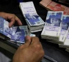 an employee counts pakistani rupee notes at a bank in peshawar pakistan august 22 2023 photo reuters