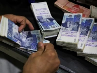 an employee counts pakistani rupee notes at a bank in peshawar pakistan august 22 2023 photo reuters