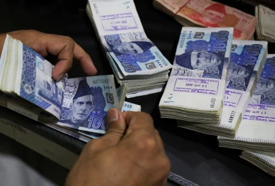 an employee counts pakistani rupee notes at a bank in peshawar pakistan august 22 2023 photo reuters
