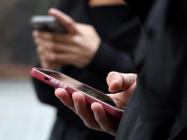 teenagers look at their mobile phone screens in paris france february 20 2026 photo reuters teenagers look at their mobile phone screens in paris france february 20 2026 photo reuters