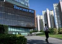 a man walks past the tencent headquarters in shenzhen in china s southern guangdong province photo afp