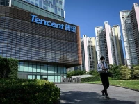 a man walks past the tencent headquarters in shenzhen in china s southern guangdong province photo afp