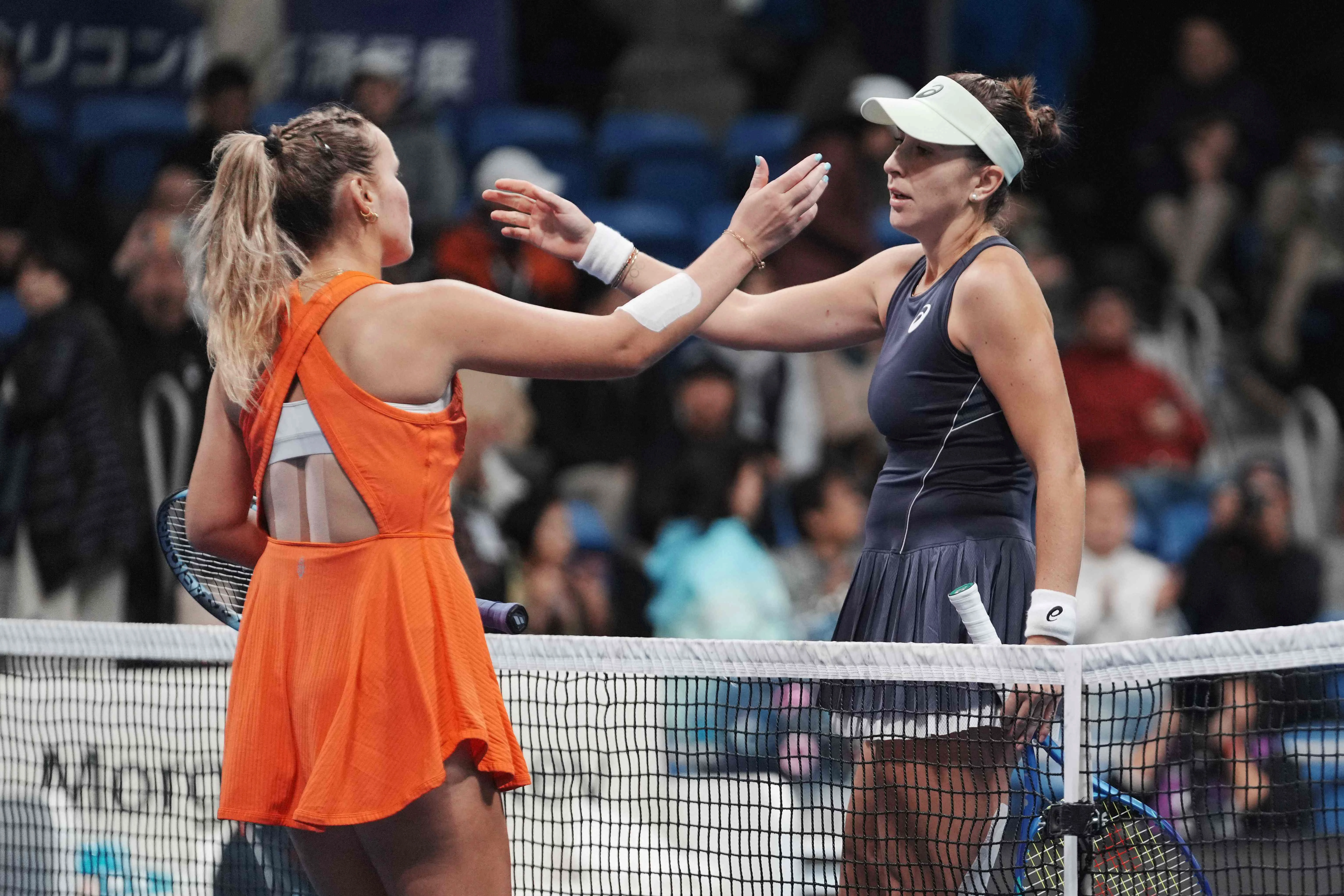 switzerland s belinda bencic r and usa s sofia kenin approach each other for a hug after their women s singles semi finals at the pan pacific open tennis tournament in tokyo on october 25 2025 photo afp