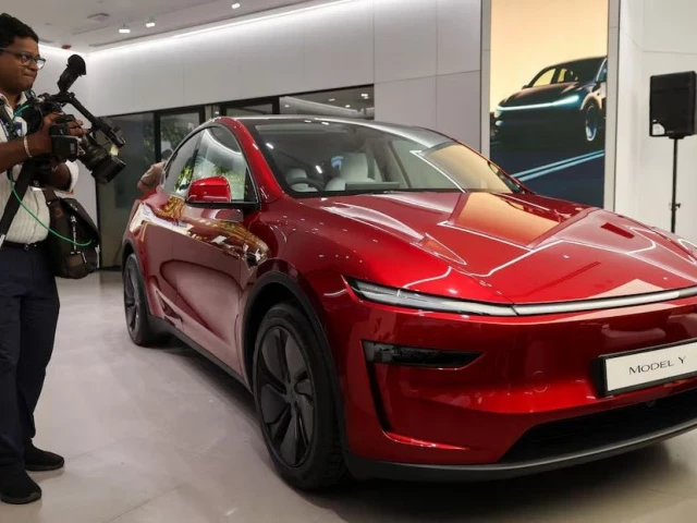 a media personnel walks past a tesla model y car at india s first tesla showroom in mumbai india july 15 2025 photo reuters a media personnel walks past a tesla model y car at india s first tesla showroom in mumbai india july 15 2025 photo reuters