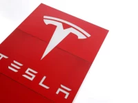 the logo of car manufacturer tesla is seen at a dealership in london britain may 14 2021 reuters