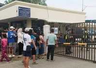 people stand outside ateneo de zamboanga university after a shooting that killed two people in zamboanga southern philippines august 18 2026 photo reuters