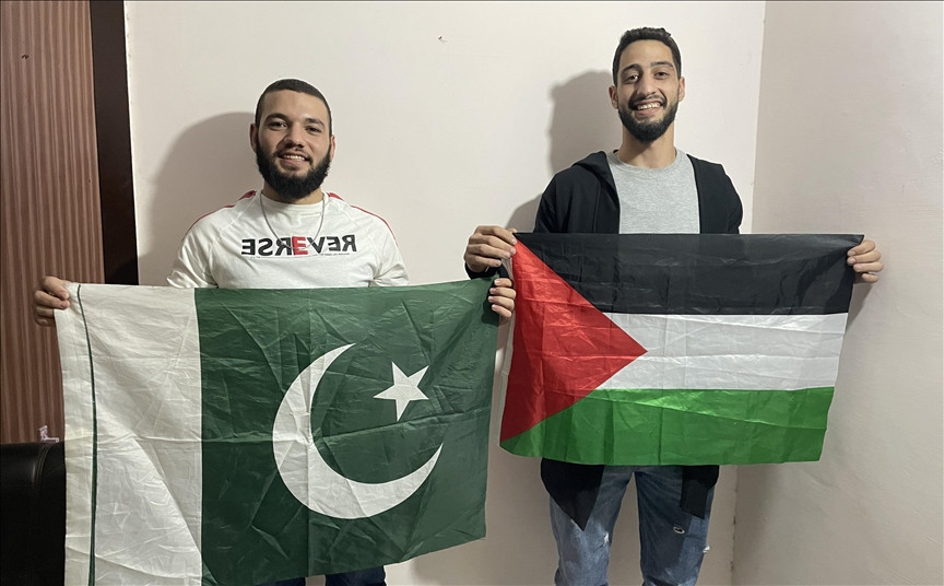 two student hold flags as hundreds of students recently gathered at a university in lahore to show solidarity with the people of palestine photo aa