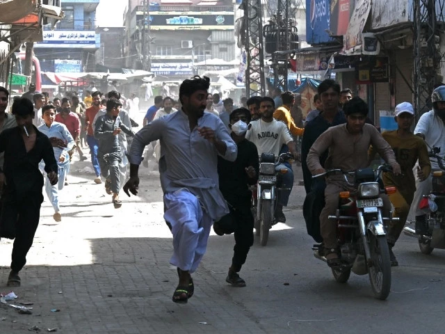 tlp party activists run as they escape police personnel during an anti israel protest in muridke on october 13 photo afp