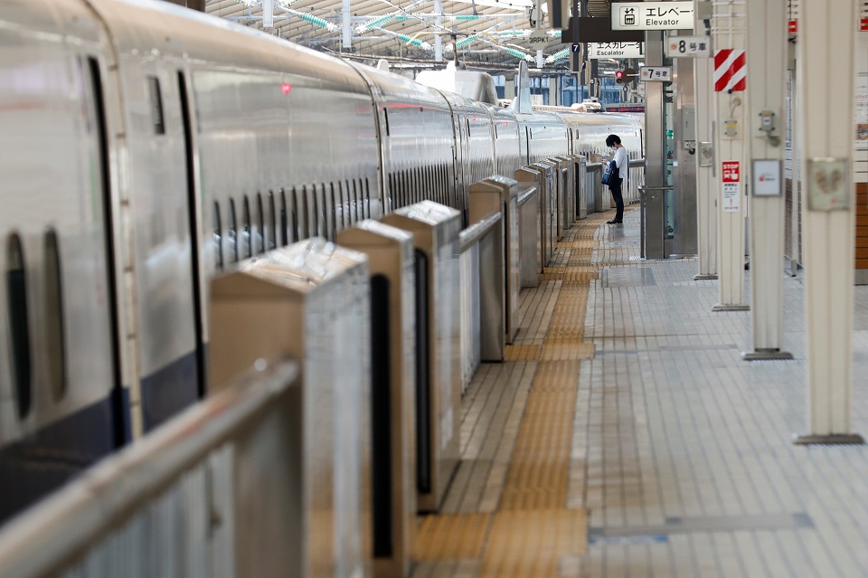 A passenger wearing a face mask waits for a train on an almost empty platform of Tokyo station where fewer people than usual are seen during Golden Week holidays following the coronavirus disease (COVID-19) outbreak, in Tokyo, Japan, April 29, 2020.REUTERS/Kim Kyung-Hoon